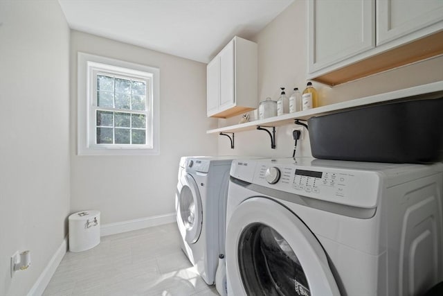 laundry room with cabinets and washing machine and dryer