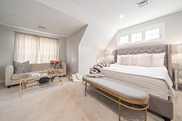 carpeted bedroom with lofted ceiling