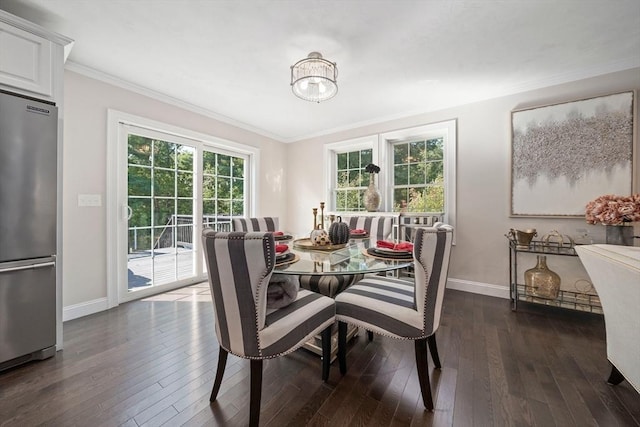 dining room with ornamental molding, a notable chandelier, and dark hardwood / wood-style flooring