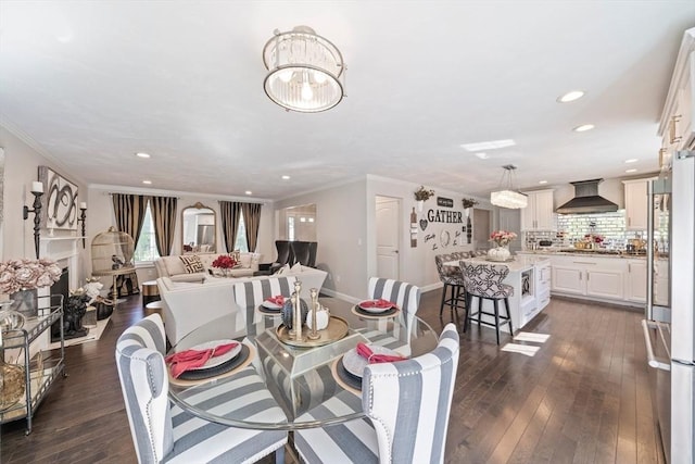 dining area featuring a notable chandelier, dark wood-type flooring, and ornamental molding