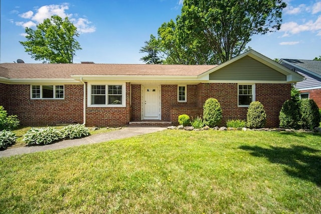 single story home with a front lawn and brick siding