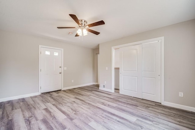 interior space featuring a closet, wood finished floors, and baseboards