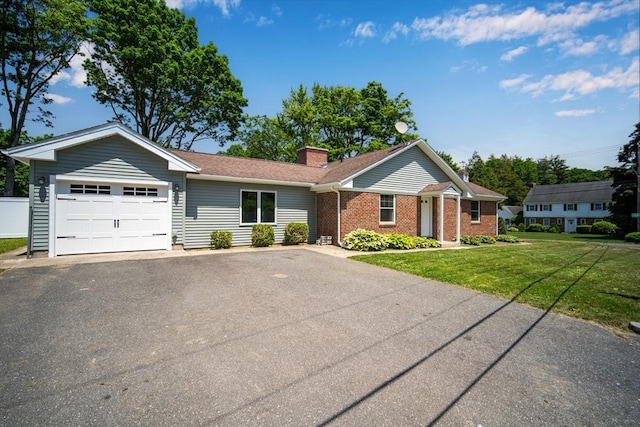 single story home with a garage, driveway, a chimney, a front lawn, and brick siding