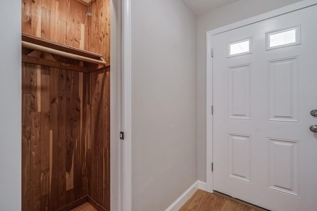 foyer featuring light wood-style flooring and baseboards