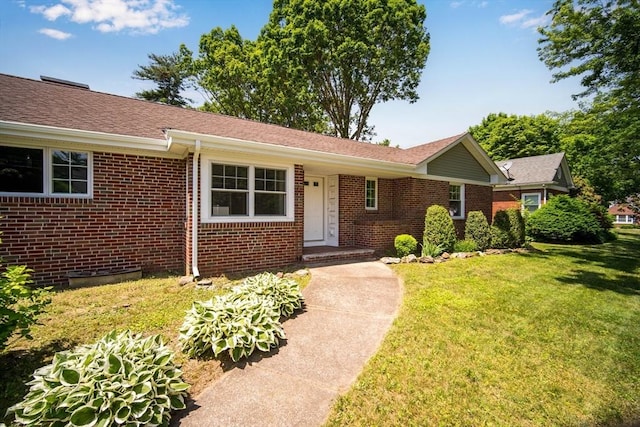 single story home with a front yard and brick siding