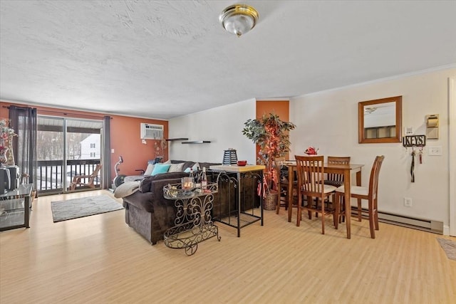 living room with crown molding, a textured ceiling, a wall unit AC, and light hardwood / wood-style flooring