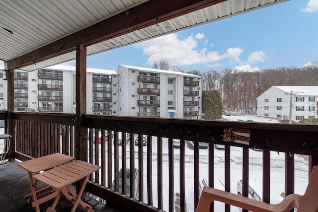 view of snow covered back of property