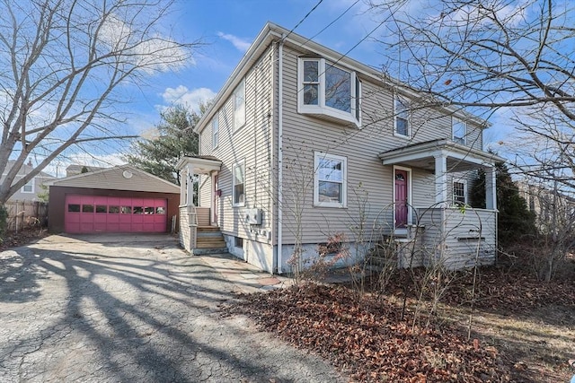 view of front of home featuring a garage and an outdoor structure