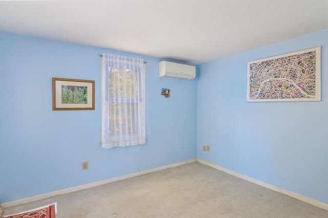 spare room featuring an AC wall unit, baseboards, and carpet floors