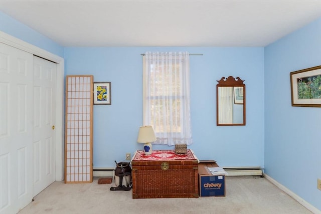 interior space with a baseboard radiator, baseboards, carpet, and a closet