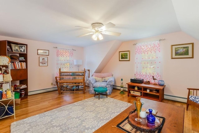 interior space with baseboard heating, a ceiling fan, and wood finished floors