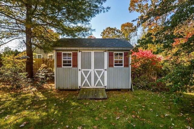 view of shed with fence