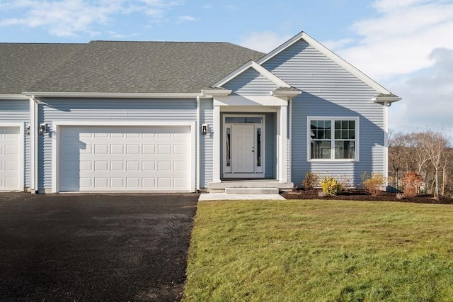 view of front of home with a garage, a shingled roof, a front lawn, and aphalt driveway