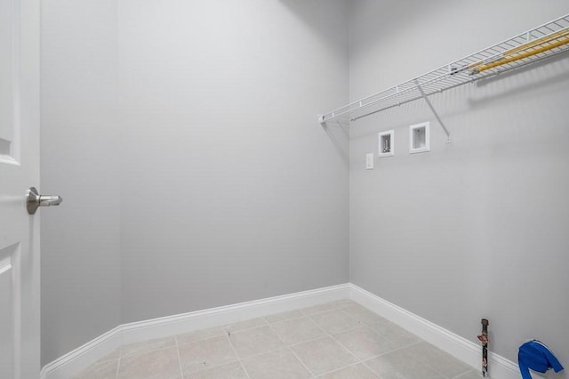 laundry area with washer hookup, laundry area, baseboards, and light tile patterned floors