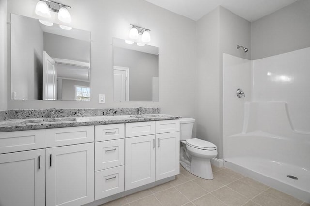 bathroom featuring tile patterned floors, a sink, toilet, and walk in shower