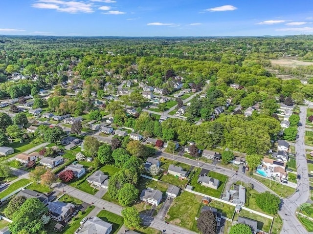 aerial overview of property's location featuring a heavily wooded area and nearby suburban area