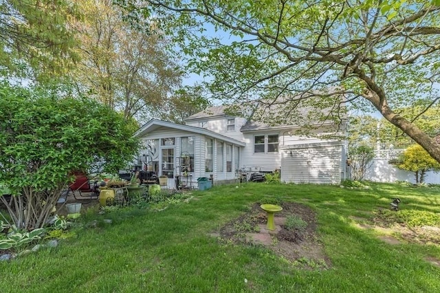 back of property featuring a yard and a sunroom