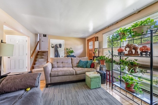 living area featuring stairway and light wood finished floors