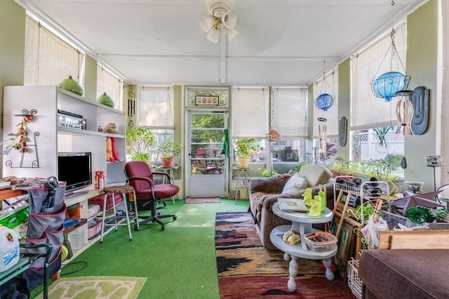 sunroom featuring ceiling fan, plenty of natural light, and carpet