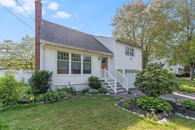 tri-level home featuring a chimney, a shingled roof, and an attached garage