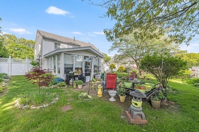 back of property with a sunroom