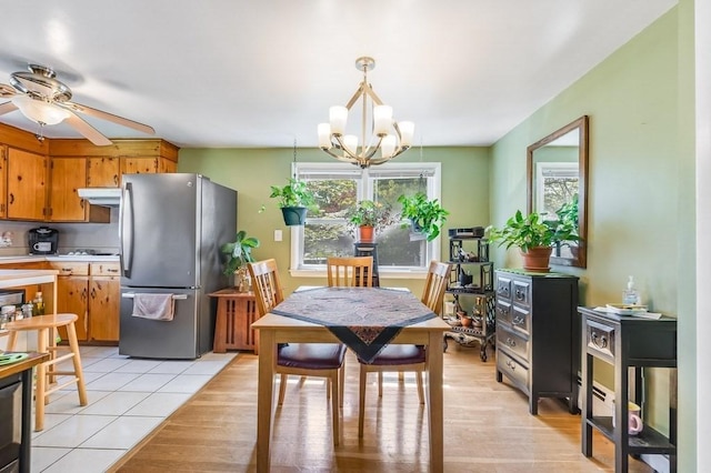 dining room with a chandelier, ceiling fan, and light tile patterned floors