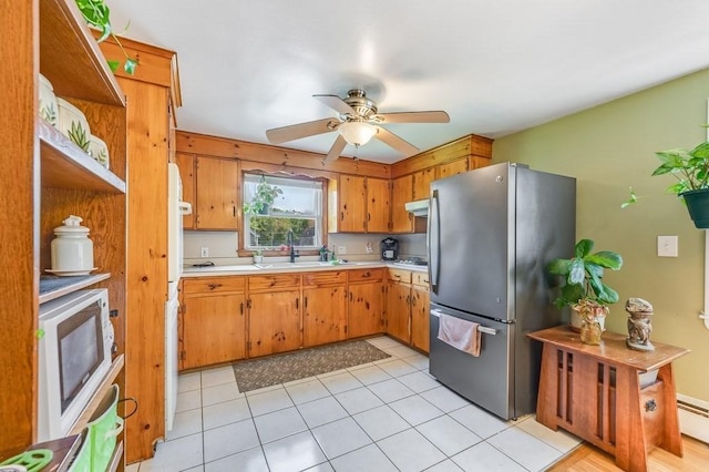 kitchen with freestanding refrigerator, light countertops, open shelves, ceiling fan, and under cabinet range hood