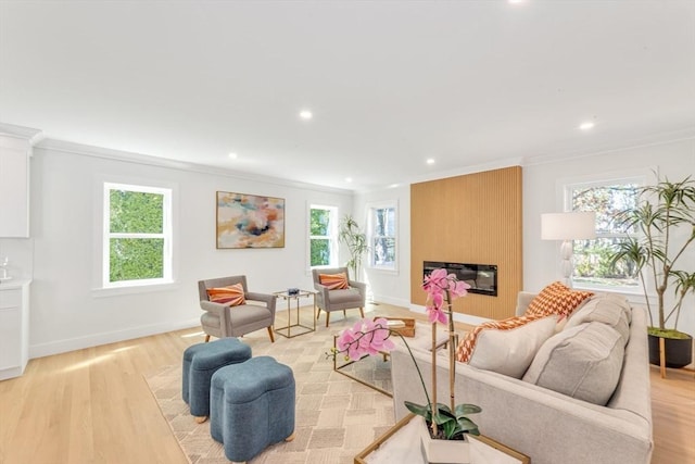 living room with recessed lighting, ornamental molding, and plenty of natural light