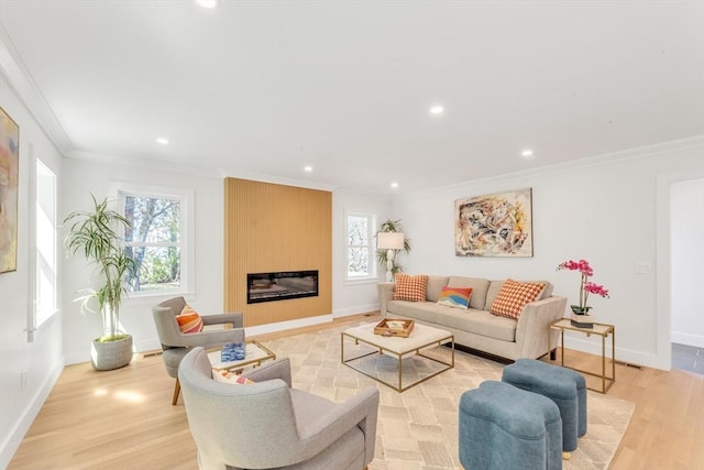 living room featuring crown molding, recessed lighting, light wood-style floors, and a large fireplace
