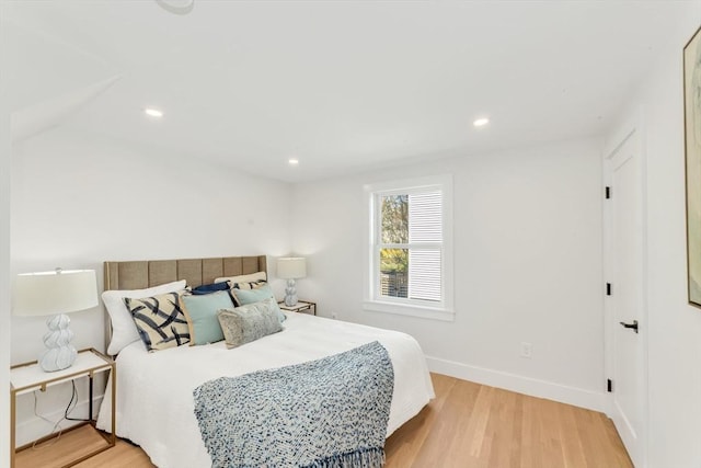 bedroom with recessed lighting, baseboards, and wood finished floors