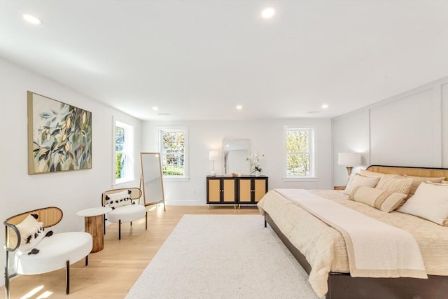 bedroom with recessed lighting and light wood-style floors