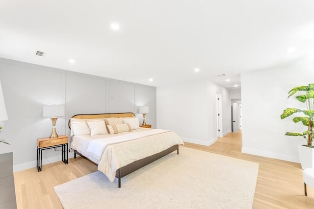 bedroom with light wood-type flooring, recessed lighting, and visible vents