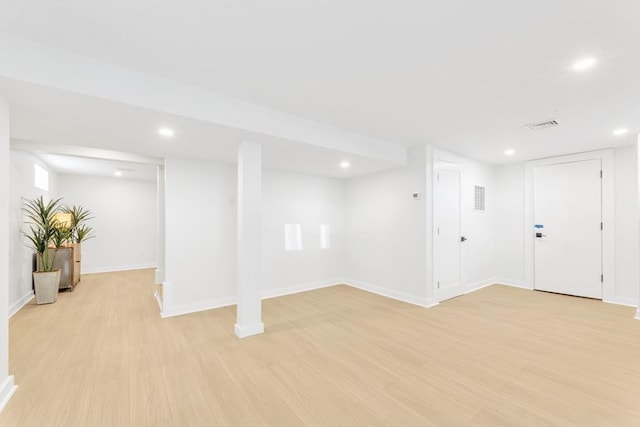 finished below grade area featuring recessed lighting, baseboards, visible vents, and light wood-type flooring