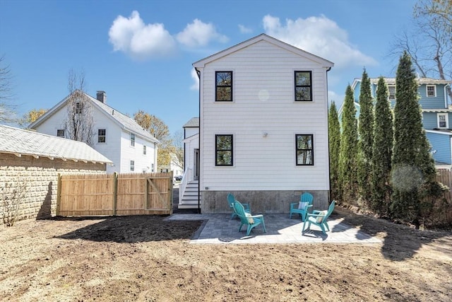 back of property featuring fence and a patio