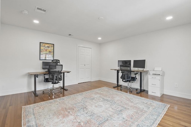 office featuring baseboards, wood finished floors, visible vents, and recessed lighting