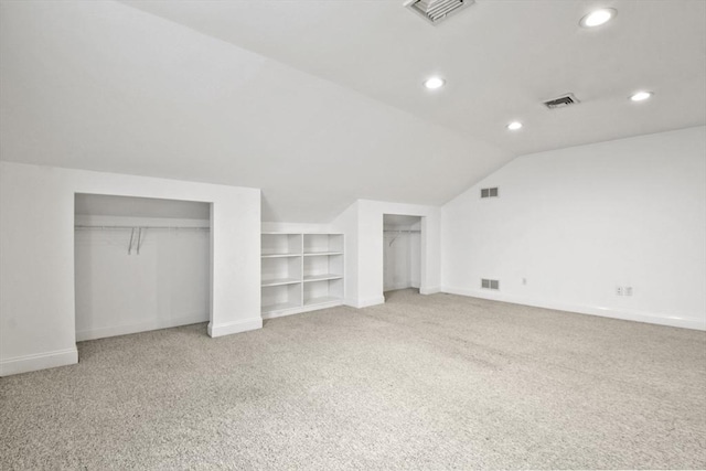 bonus room with lofted ceiling and visible vents