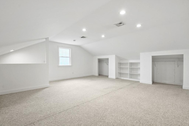 bonus room with lofted ceiling, visible vents, baseboards, and recessed lighting