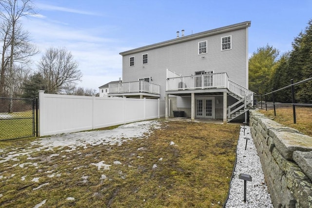 rear view of house with a wooden deck, fence, cooling unit, and french doors