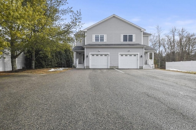 exterior space featuring a garage, fence, and driveway