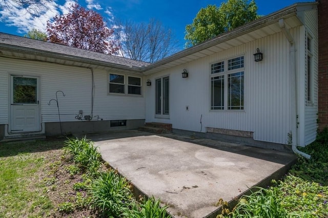 rear view of property with entry steps and a patio area