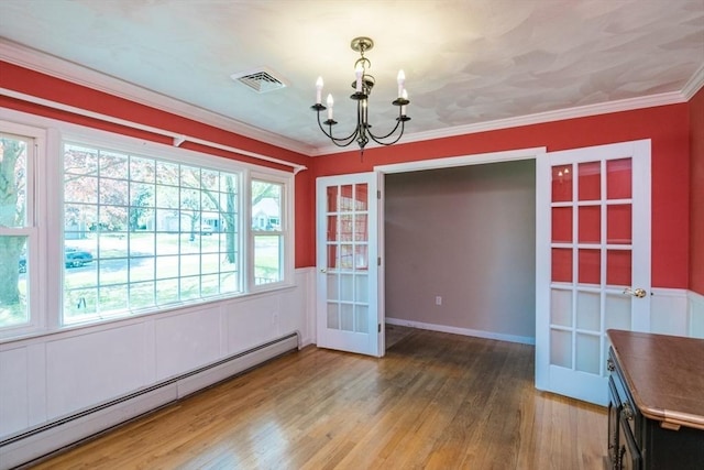 unfurnished dining area with visible vents, wood finished floors, a baseboard heating unit, a chandelier, and french doors