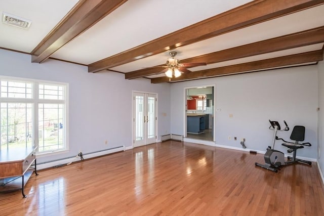 unfurnished living room with visible vents, baseboards, beam ceiling, and a healthy amount of sunlight