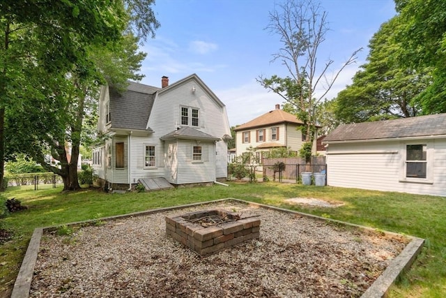 14 E Division St, Holbrook, MA 02343 - back of house with a gambrel roof, a shingled roof, an outdoor fire pit, and a chimney
