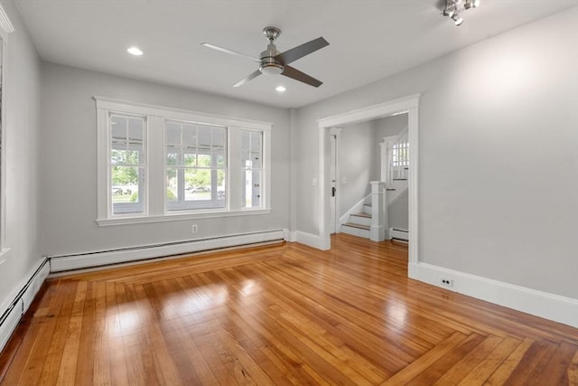 14 E Division St, Holbrook, MA 02343 - unfurnished room with a ceiling fan, a baseboard heating unit, baseboards, wood finished floors, and recessed lighting
