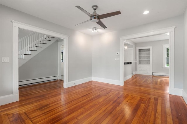 14 E Division St, Holbrook, MA 02343 - unfurnished room featuring baseboard heating, a ceiling fan, wood-type flooring, stairs, and recessed lighting