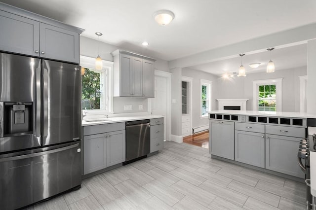 14 E Division St, Holbrook, MA 02343 - kitchen featuring appliances with stainless steel finishes, gray cabinets, light countertops, baseboard heating, and decorative light fixtures