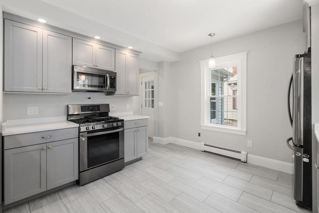 14 E Division St, Holbrook, MA 02343 - kitchen with stainless steel appliances, baseboard heating, gray cabinets, baseboards, and light countertops