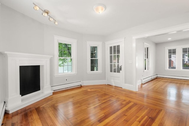 14 E Division St, Holbrook, MA 02343 - unfurnished living room featuring baseboard heating, a baseboard heating unit, and baseboards