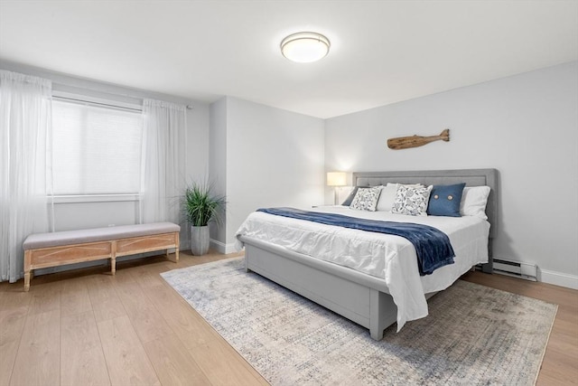 bedroom featuring hardwood / wood-style flooring and a baseboard radiator