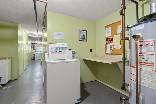 interior space with independent washer and dryer, a textured ceiling, and gas water heater